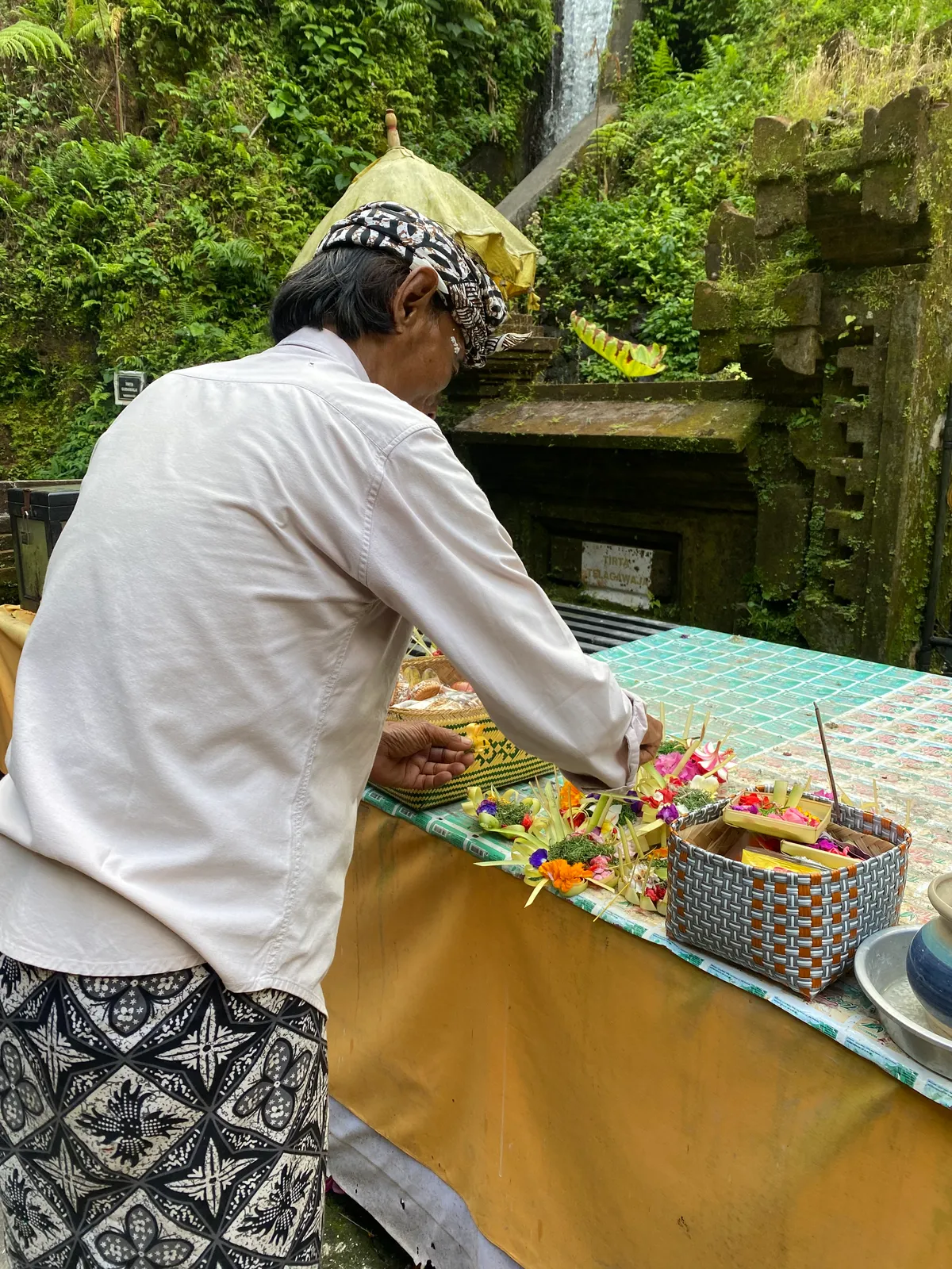 Final offering placement at the temple altar at sunset
