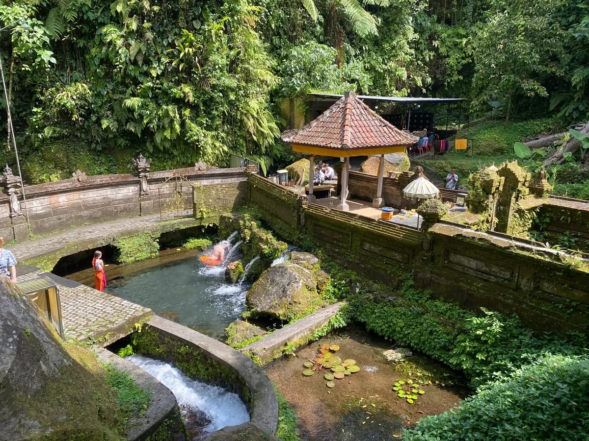 Sacred spring water cascading over ancient temple stones